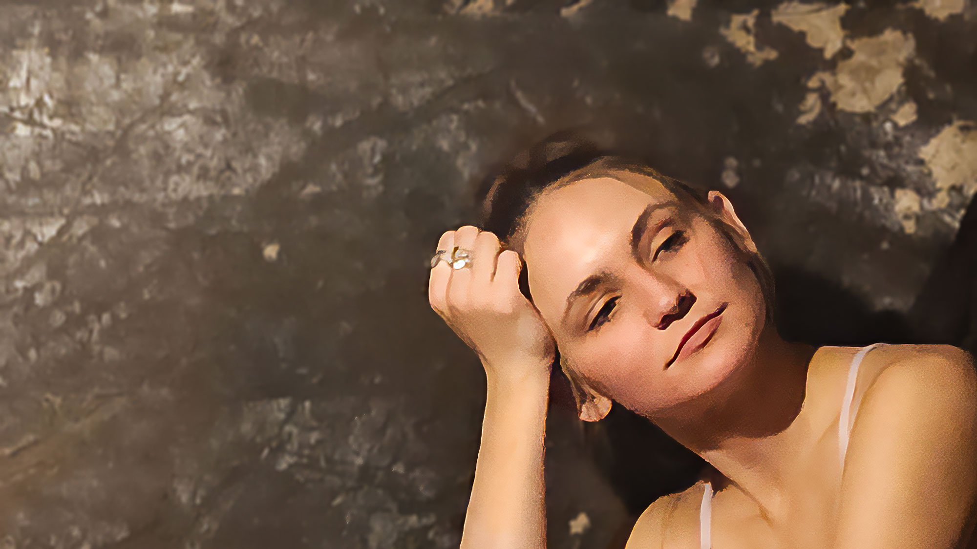 A person with closed eyes and a relaxed expression rests their head against their hand, reminiscent of a serene spa treatment. The background is rough, textured, and poorly lit, adding contrast to the tranquility.